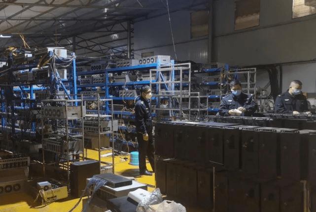 A large mining farm with rows of mining rigs operating.